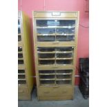 A mid-20th Century fitted oak haberdashery shop cabinet
