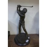 A bronze figure of a golfer