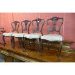 A set of four Edward VII carved mahogany salon chairs