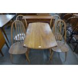 An Ercol drop leaf table and four chairs