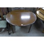 A mahogany extending dining table