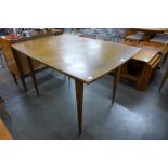 A teak extending dining table