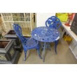 A painted cast alloy garden table and two chairs