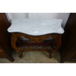 A small rococo style mahogany and marble topped console table
