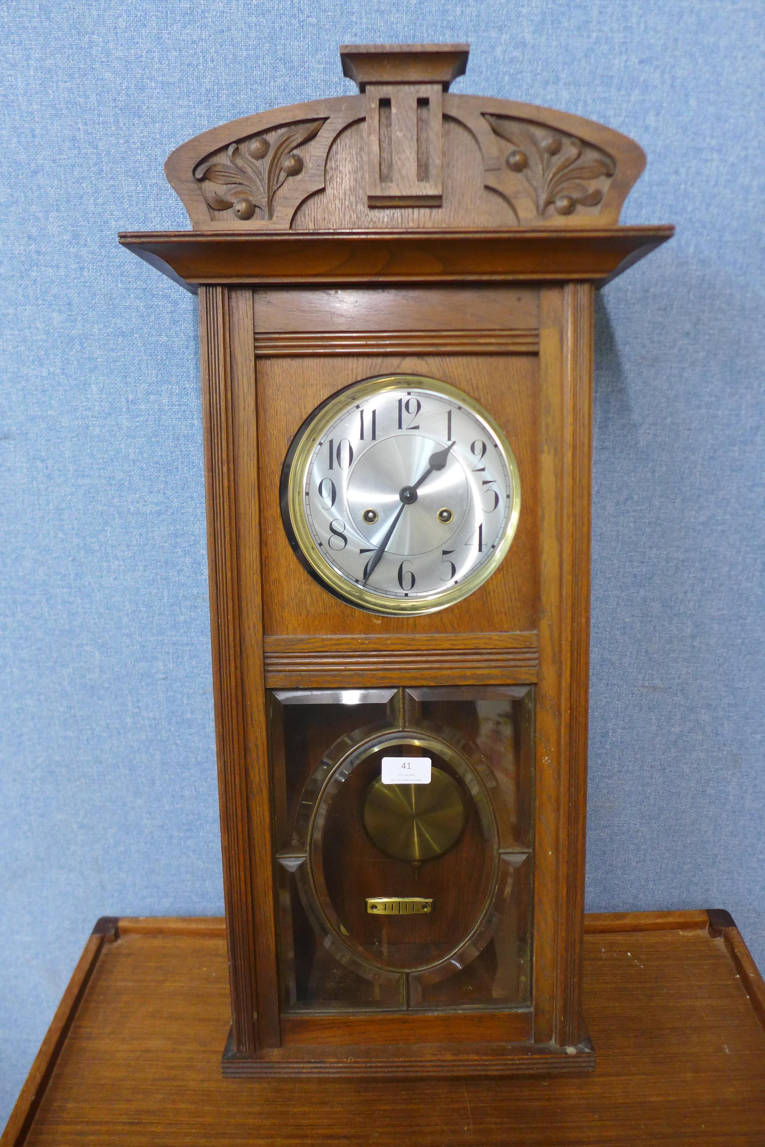 An early 20th Century oak wall clock