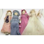 A wax head doll and three peg dolls