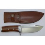 A hunting knife with leather scabbard