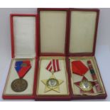 Three medals, two Bulgarian and one Hungarian, cased