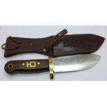 A hunting knife with leather scabbard