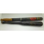 Two Victorian painted police truncheons, one with crown and turned handle