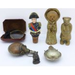 A gold plated monacle, a brass bear, two opium bottles, etc.