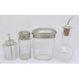 Two silver topped bottles, a silver topped glass oil pourer and one other silver topped item (4)
