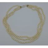 A silver mounted three strand pearl necklace