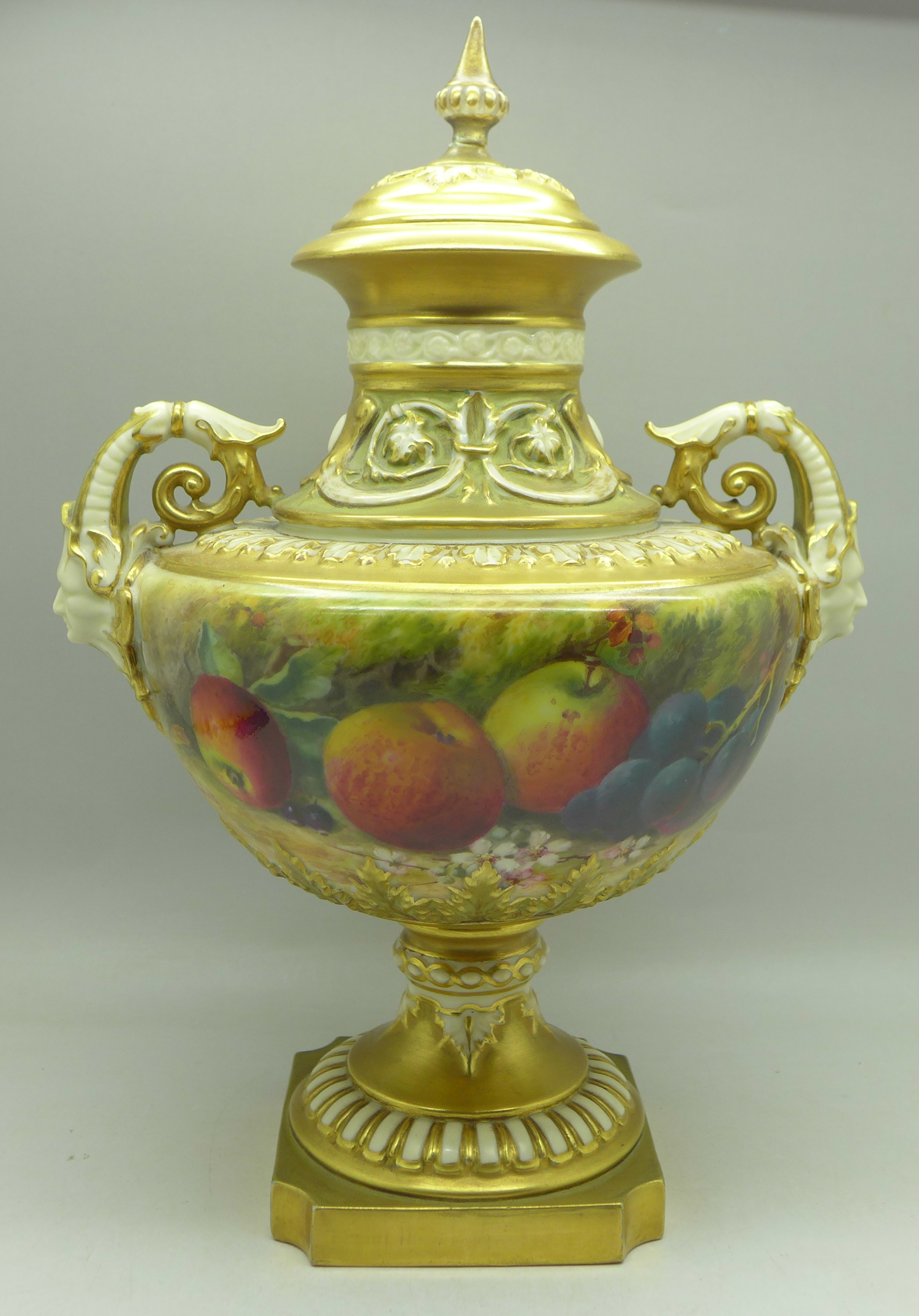 A 1925 Royal Worcester hand decorated lidded vase, 1572, signed (William) Ricketts, finial on lid