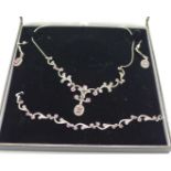 A silver, ruby and marcasite necklace, bracelet and earrings, boxed