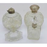 Three silver mounted glass scent bottles, one lacking top, one other glass scent bottle and two