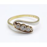 An 18ct gold, three stone diamond crossover ring, 2.8g, P