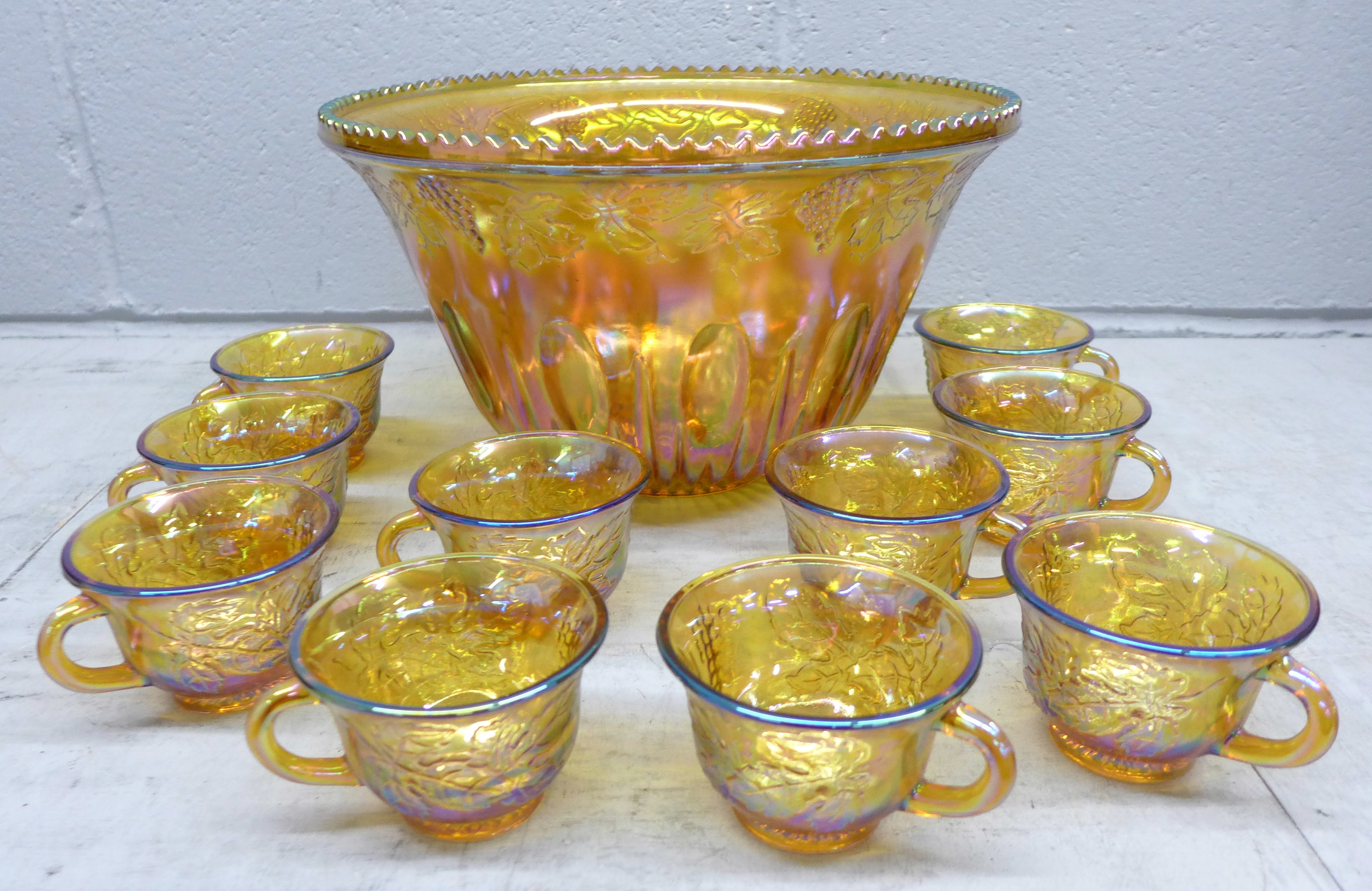 A Carnival glass punch bowl and ten glasses **PLEASE NOTE THIS LOT IS NOT ELIGIBLE FOR POSTING AND