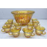 A Carnival glass punch bowl and ten glasses **PLEASE NOTE THIS LOT IS NOT ELIGIBLE FOR POSTING AND