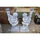 A pair of painted wood cherub table lamps