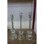 A pair of cut glass table lamps and one other