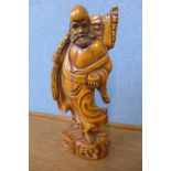 An oriental carved wood figure of a sage