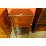 A Victorian inlaid mahogany music cabinet