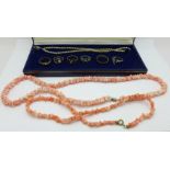 A coral necklace, one other shell necklace, costume rings and a faux pearl necklace