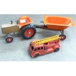 A vintage toy tractor with trailer and a Tri-ang Minic fire engine