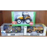 Three die-cast vehicles, two Ertl and a Siku tractor