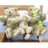 Four Steiff Teddy bears, two with growlers and one small, on a wooden Windsor style seat, (four