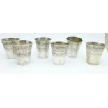 A set of six small white metal cups