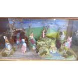 A Beatrix Potter Peter Rabbit shop display diorama containing eight figures, in a glass display