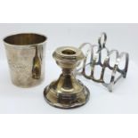 A silver toast rack, silver candle stick, a/f, and a continental measuring cup/beaker