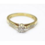 A 9ct gold and diamond solitaire ring with diamond set shoulders, 3.1g, P