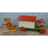 A vintage pull along dog in kennel and a Levi wooden football player