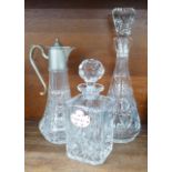 A glass claret jug and two crystal glass decanters, one with a Royal Adderley whisky label