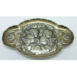 A silver pin tray decorated with Reynolds angels, by William Comyns, 41g, 12cm