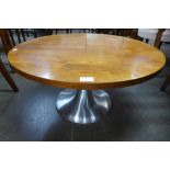 A teak circular coffee table on chrome base