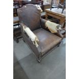 A 1920's mahogany and leather upholstered armchair