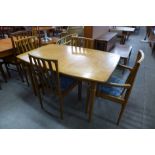 A Meredew teak extending dining table and four chairs