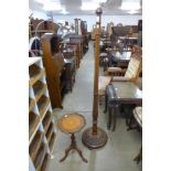 A carved beech standard lamp and a tripod table