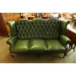 A green leather Chesterfield wingback settee