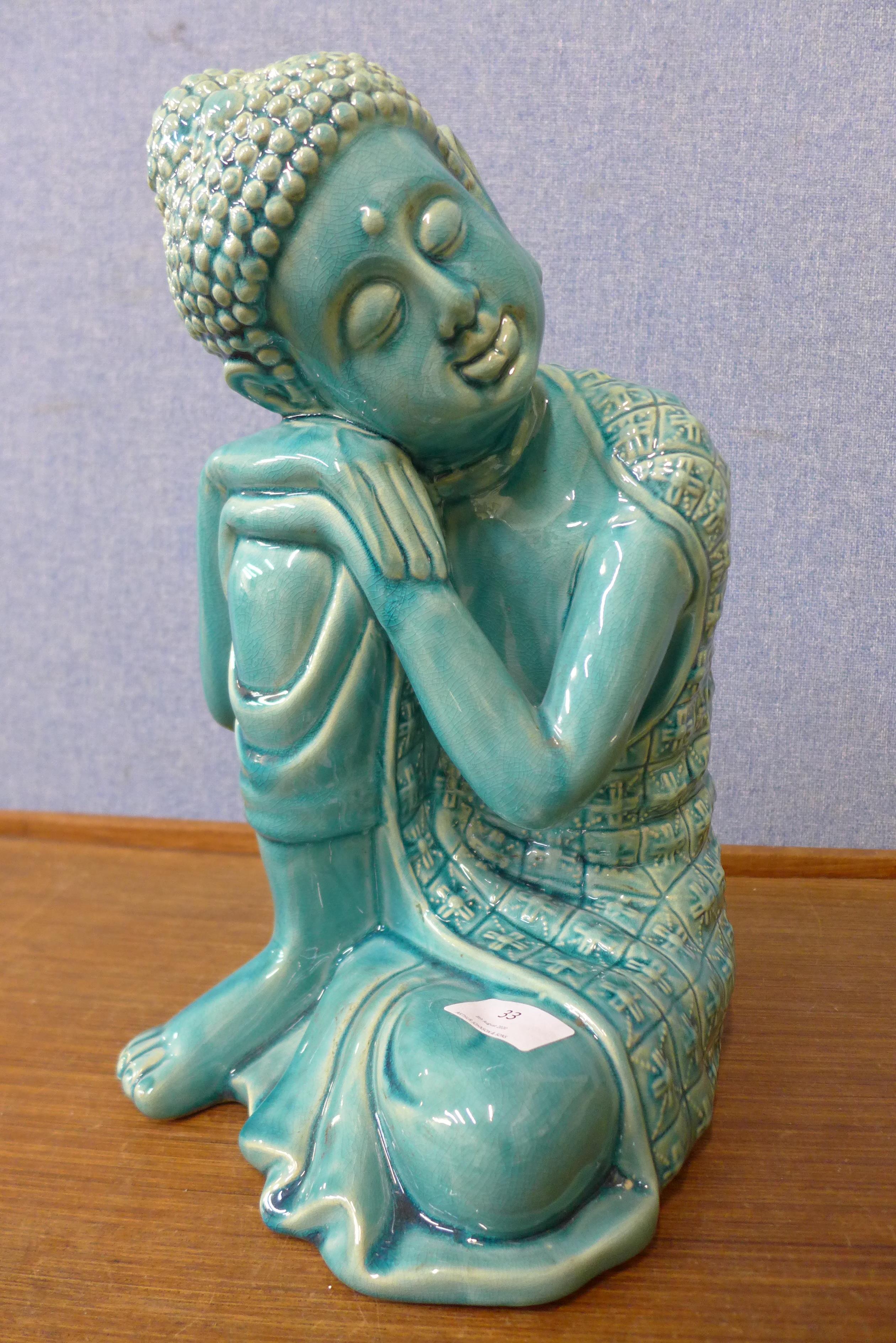 A turquoise glazed porcelain figure of an eastern deity