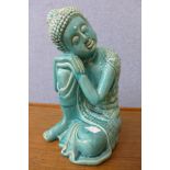 A turquoise glazed porcelain figure of an eastern deity