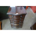 A small mahogany serpentine chest of drawers