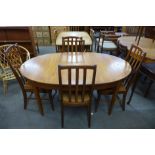 A teak extending dining table and four chairs