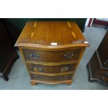 A yew wood serpentine chest of drawers