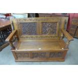 An Elizabethan Revival carved oak monks bench