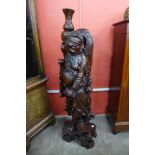 An oriental carved hardwood figure of a Buddha and komodo dragon, 111cms h